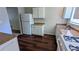 Efficient kitchen features a refrigerator, stainless steel sink, and wood-look flooring, all in a compact space at 5266 Long Green Ln, Stone Mountain, GA 30088