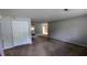Spacious living room with plush carpeting and a neutral color palette, open to dining area and kitchen at 5266 Long Green Ln, Stone Mountain, GA 30088