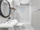 Bathroom with classic pedestal sink, tiled shower/tub combo, and modern fixtures at 974 Greenwood Ne Ave # 6, Atlanta, GA 30306