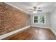 Bedroom featuring hardwood flooring, exposed brick wall, ample natural light, and neutral decor at 974 Greenwood Ne Ave # 6, Atlanta, GA 30306