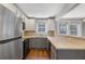 Charming kitchen with stainless appliances, two-tone cabinets, tile backsplash, and hardwood floors at 974 Greenwood Ne Ave # 6, Atlanta, GA 30306