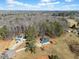 Aerial view of homes showcasing their setting among lush trees with expansive driveways at 104 Federal Path, Temple, GA 30179