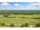 Panoramic aerial view of a sprawling landscape featuring lush green fields and scattered trees at 104 Federal Path, Temple, GA 30179