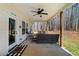 Covered back porch with outdoor seating area, ceiling fan, and backyard view at 104 Federal Path, Temple, GA 30179