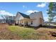 Backyard featuring a covered porch, well-maintained lawn, with string lights, and clear skies at 104 Federal Path, Temple, GA 30179