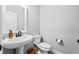 Half-bathroom features a pedestal sink, modern faucet, and neutral wall color at 104 Federal Path, Temple, GA 30179