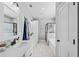 Bright bathroom with double sinks, white cabinets, a bathtub, a glass-enclosed shower, and a tiled floor at 104 Federal Path, Temple, GA 30179