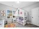 A cute bedroom featuring a bunk bed in the shape of a house with a colorful rug at 104 Federal Path, Temple, GA 30179