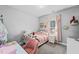 Bright bedroom featuring a white metal bed frame, pink curtains, and soft carpet at 104 Federal Path, Temple, GA 30179