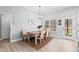 Charming dining area with a rustic wooden table, bench seating, modern light fixture, and natural light at 104 Federal Path, Temple, GA 30179