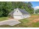 A view of the exterior of the home with its well-kept lawn and two-car garage at 104 Federal Path, Temple, GA 30179