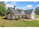 Exterior view of home showcasing the roofline, manicured lawn and covered front porch at 104 Federal Path, Temple, GA 30179