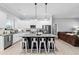 Modern kitchen featuring white cabinets, granite countertops, stainless steel appliances, and a large island with seating at 104 Federal Path, Temple, GA 30179