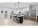Bright kitchen featuring stainless appliances, white cabinets, and an island with seating at 104 Federal Path, Temple, GA 30179