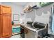 Well-equipped laundry room featuring a washer, a dryer, wooden cabinets, shelving, and ample storage space at 104 Federal Path, Temple, GA 30179