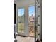 Balcony view with seating and bright lighting from large open door and beautiful view of other homes at 11189 Serenbe Ln, Chattahoochee Hills, GA 30268