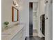 Elegant bathroom features a double vanity with marble countertops, a sliding door, and a closet at 11189 Serenbe Ln, Chattahoochee Hills, GA 30268