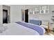 Comfortable bedroom featuring soft white linens, a blue dresser, and tasteful decor, with a black barn door at 11189 Serenbe Ln, Chattahoochee Hills, GA 30268