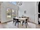 Modern dining room with hardwood floors, bright light from three windows and statement pendant light at 11189 Serenbe Ln, Chattahoochee Hills, GA 30268