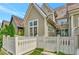Exterior shot of a home with vertical siding, white trim, nice windows, and a private fenced-in patio at 11189 Serenbe Ln, Chattahoochee Hills, GA 30268