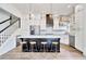 Modern kitchen features stainless steel appliances, white cabinets, and a large island with bar seating at 11189 Serenbe Ln, Chattahoochee Hills, GA 30268