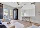 Inviting living room with stylish seating, dark cabinetry, and French doors offering natural light at 11189 Serenbe Ln, Chattahoochee Hills, GA 30268