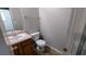 Half bathroom featuring a pedestal sink, tile flooring, and a toilet, providing essential functionality at 1780 Spring Hill Cv, Lithonia, GA 30058