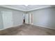 Large primary bedroom featuring carpet flooring, neutral walls, and access to an en-suite bathroom, creating a serene space at 1780 Spring Hill Cv, Lithonia, GA 30058