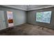 Large primary bedroom featuring carpet flooring, neutral walls, a ceiling fan, and access to an en-suite bathroom at 1780 Spring Hill Cv, Lithonia, GA 30058