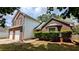 View of the brick home highlighting the attached two-car garage at 1780 Spring Hill Cv, Lithonia, GA 30058