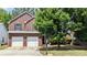 Beautiful two-story brick home with a well-maintained front yard and mature trees at 1780 Spring Hill Cv, Lithonia, GA 30058