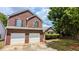 Charming brick home with a two-car garage and well-manicured landscaping at 1780 Spring Hill Cv, Lithonia, GA 30058