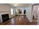 Open-concept living room with laminate flooring, fireplace, and adjacent kitchen, offering a harmonious living space at 1780 Spring Hill Cv, Lithonia, GA 30058