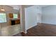 Open floorplan view of the hardwood floors and kitchen beyond at 1780 Spring Hill Cv, Lithonia, GA 30058