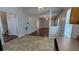 Open-concept living room with laminate flooring, neutral walls, and access to a staircase, creating a welcoming atmosphere at 1780 Spring Hill Cv, Lithonia, GA 30058