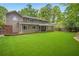 Large backyard with a manicured lawn, partially fenced in, and well-maintained landscaping at 3932 Granger Dr, Brookhaven, GA 30341
