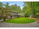 Expansive backyard features lush artificial turf and a charming shed/playhouse at 3932 Granger Dr, Brookhaven, GA 30341