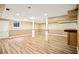 Finished basement featuring sleek floors, recessed lighting, columns, and bar at 3932 Granger Dr, Brookhaven, GA 30341