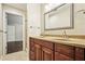 Bathroom features a double sink vanity with wooden cabinets and glass shelves at 3932 Granger Dr, Brookhaven, GA 30341