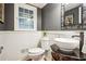 Charming powder room with a vessel sink, dark grey walls and a decorative mirror at 3932 Granger Dr, Brookhaven, GA 30341