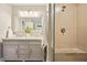Modern bathroom features a double vanity and a glass-enclosed shower with stone accents at 3932 Granger Dr, Brookhaven, GA 30341