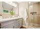 Modern bathroom features a double vanity and a glass-enclosed shower with stone accents at 3932 Granger Dr, Brookhaven, GA 30341
