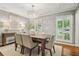 Elegant dining room featuring a chandelier, hardwood floors, neutral walls, and plantation shutters at 3932 Granger Dr, Brookhaven, GA 30341