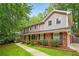 Beautiful two-story home featuring a brick facade, gray siding, and well-maintained landscaping at 3932 Granger Dr, Brookhaven, GA 30341