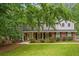 Charming two-story home with brick and siding exterior, manicured lawn, and mature trees at 3932 Granger Dr, Brookhaven, GA 30341