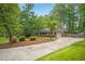 Traditional home with a long driveway, manicured lawn, and mature trees at 3932 Granger Dr, Brookhaven, GA 30341