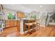 Bright kitchen features wood cabinets, granite countertops, stainless appliances, and an island with seating at 3932 Granger Dr, Brookhaven, GA 30341