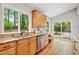 Updated kitchen with stainless steel appliances, wood cabinets, granite countertops, and a sliding door to the backyard at 3932 Granger Dr, Brookhaven, GA 30341