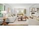 Bright living room with white walls, fireplace, hardwood floors, and stylish neutral furniture at 3932 Granger Dr, Brookhaven, GA 30341