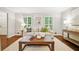 Cozy living room featuring hardwood floors, plantation shutters, and comfortable neutral furniture at 3932 Granger Dr, Brookhaven, GA 30341